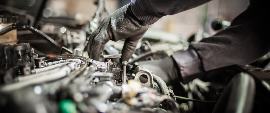 Technician checking a vehicle engine