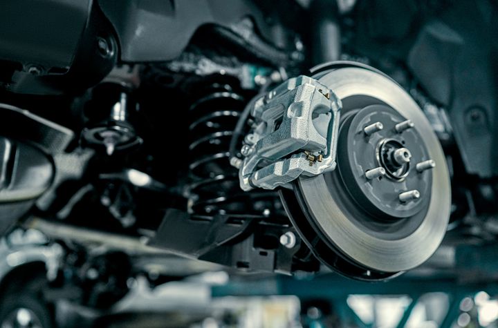 Brake caliper and rotor on a vehicle in the shop