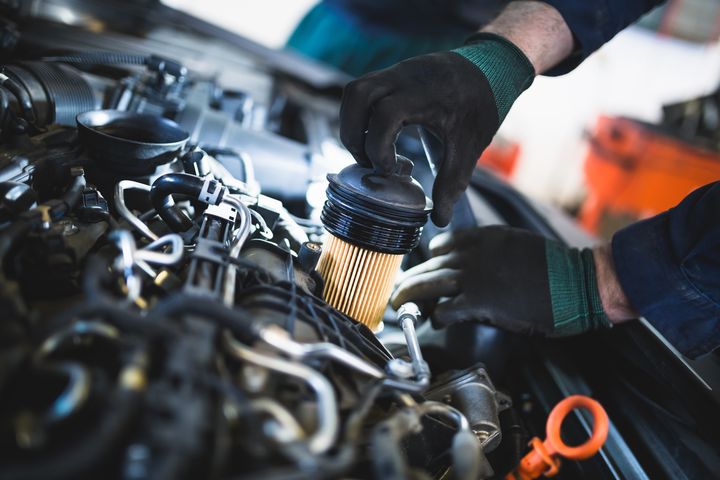 Technician holding a filter during routine service