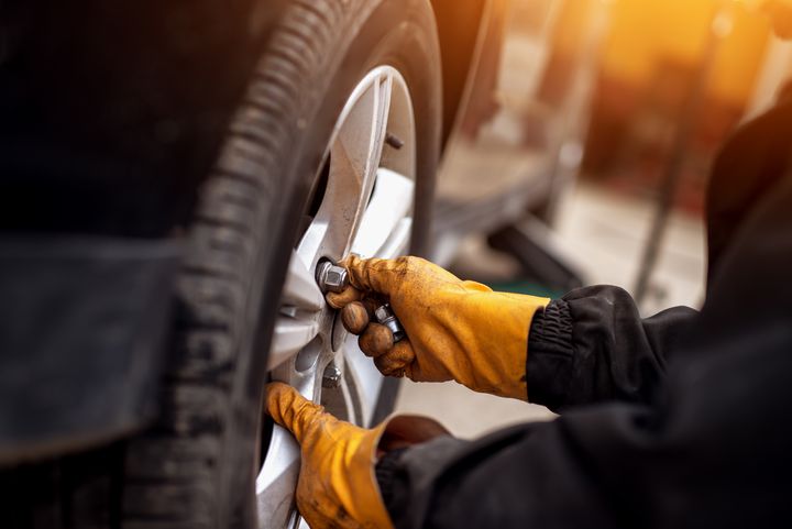 Technician torquing lug nuts on a wheel
